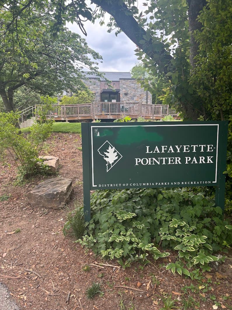 The Lafayette-Pointer Park entrance sign with the stone Recreation Center behind